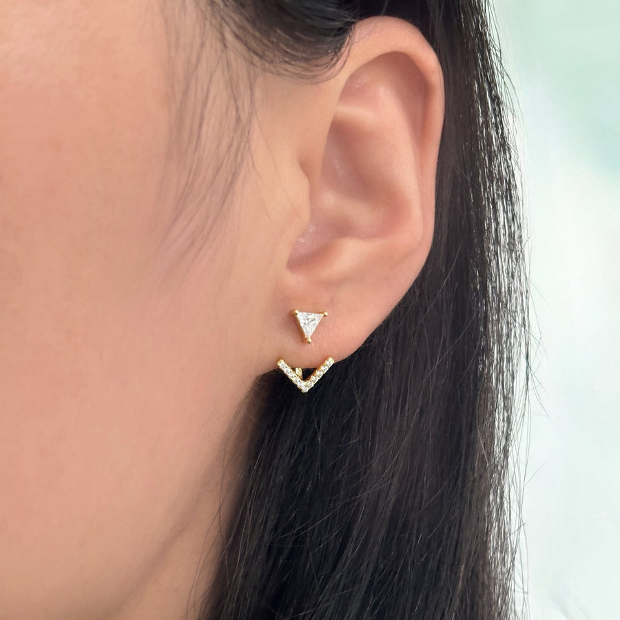 These elegant gold earrings feature a unique design with a triangular cubic zircon at the top and a V-shaped lower part adorned with sparkling cubic zircon, offering a touch of sophistication and glamour to any outfit. The combination of geometric shapes and shimmering accents makes these earrings a stylish and eye-catching accessory for any occasion.