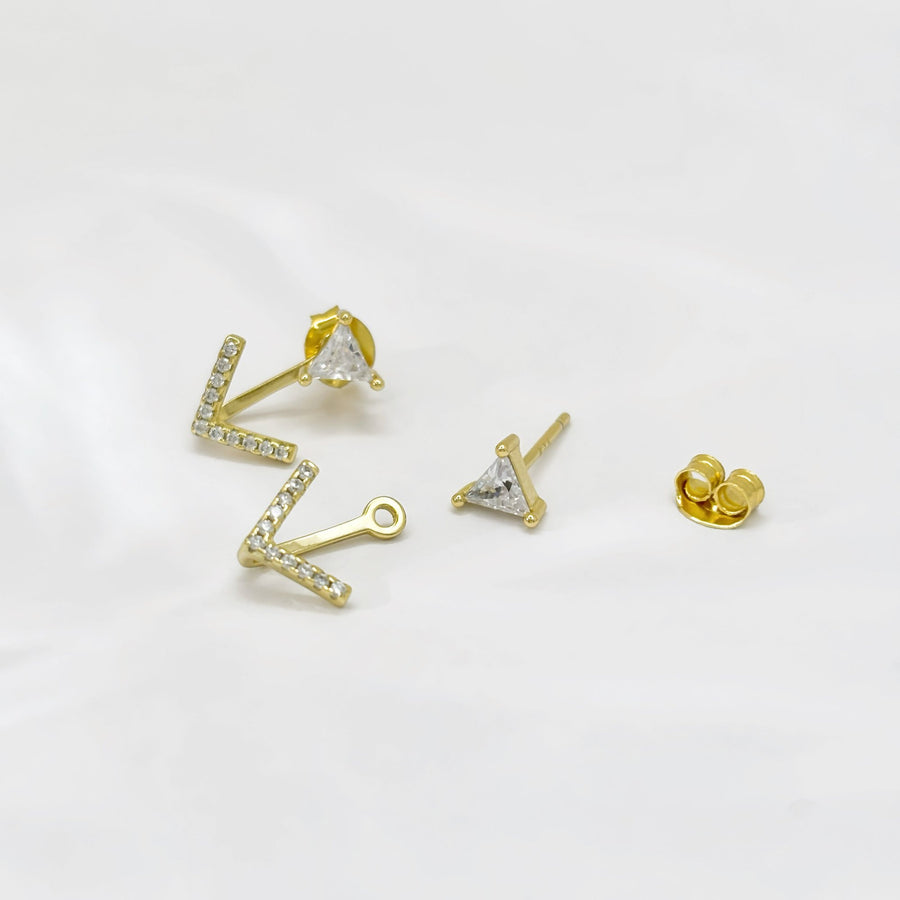 These elegant gold earrings feature a unique design with a triangular cubic zircon at the top and a V-shaped lower part adorned with sparkling cubic zircon, offering a touch of sophistication and glamour to any outfit. The combination of geometric shapes and shimmering accents makes these earrings a stylish and eye-catching accessory for any occasion.