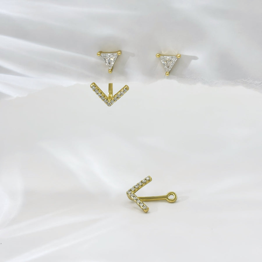 These elegant gold earrings feature a unique design with a triangular cubic zircon at the top and a V-shaped lower part adorned with sparkling cubic zircon, offering a touch of sophistication and glamour to any outfit. The combination of geometric shapes and shimmering accents makes these earrings a stylish and eye-catching accessory for any occasion.