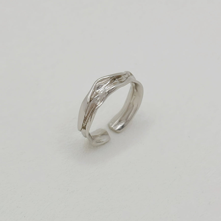 The ring features a fluid, wave-inspired design, crafted from premium 925 silver for timeless elegance. Perfect for any occasion, this adjustable ring adds a touch of sophistication and modern charm to your everyday style.