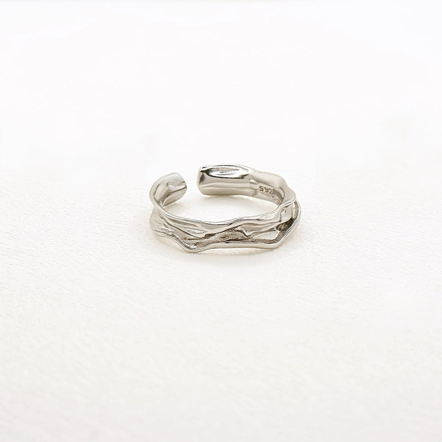 The ring features a fluid, wave-inspired design, crafted from premium 925 silver for timeless elegance. Perfect for any occasion, this adjustable ring adds a touch of sophistication and modern charm to your everyday style.