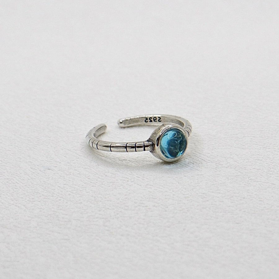 The adjustable vintage inspired silver ring features a blue crystal that adds a touch of retro charm and elegance to any outfit. Handmade, perfect for those who appreciate a touch of individuality in their accessories. 