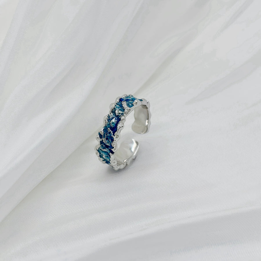 This wave-shaped silver ring, featuring a unique irregular texture and a stunning blue resin that adds a touch of sophistication and elegance to any outfit. Perfect for any occasion