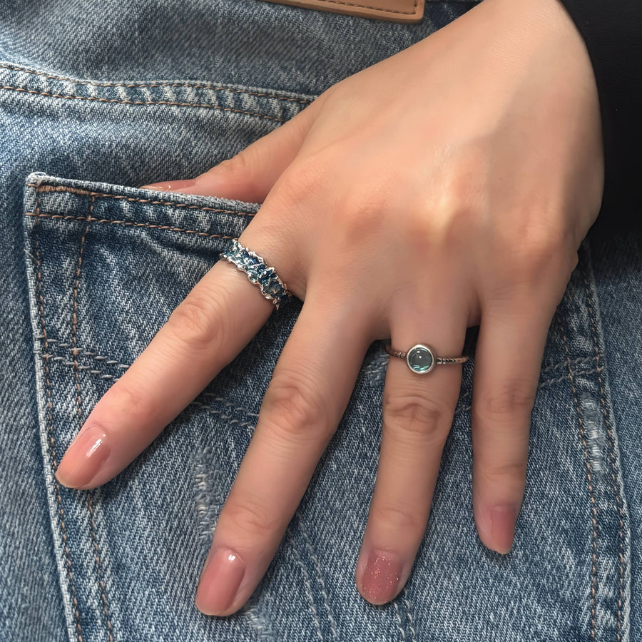 This wave-shaped silver ring, featuring a unique irregular texture and a stunning blue resin that adds a touch of sophistication and elegance to any outfit. Perfect for any occasion