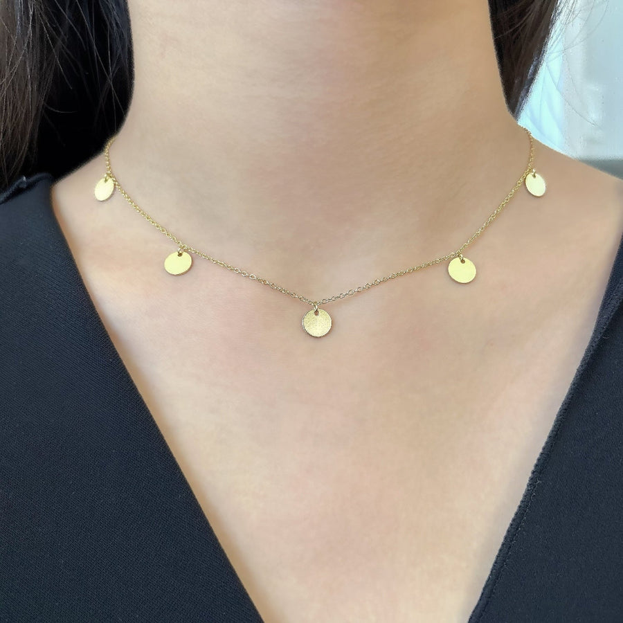 This dainty gold-plated silver necklace features delicate circular pendants, adding a touch of minimalistic charm to any outfit. Perfect for layering or wearing alone, this necklace complements both casual and formal looks effortlessly.