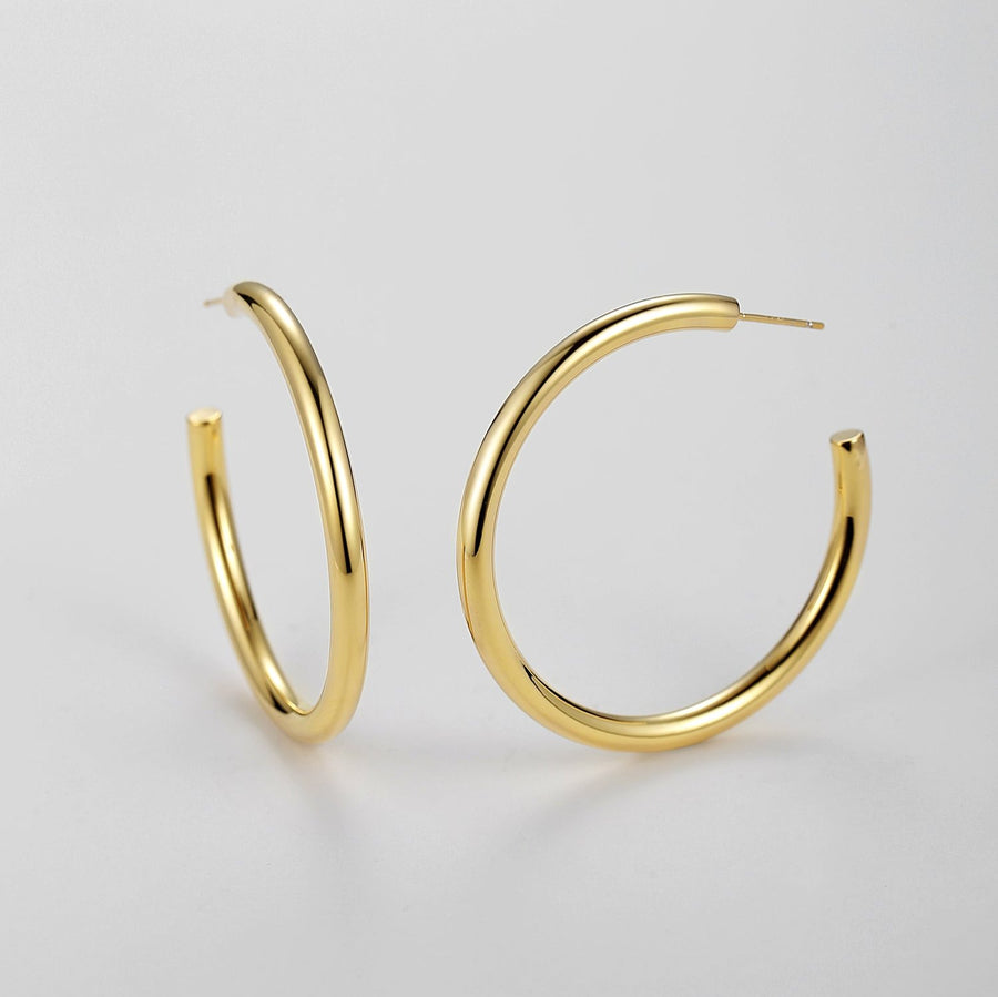 Make a bold statement with the hoop earrings, designed to complement any outfit with their timeless elegance. These large, minimalist hoops add a touch of sophistication to both casual and formal attire