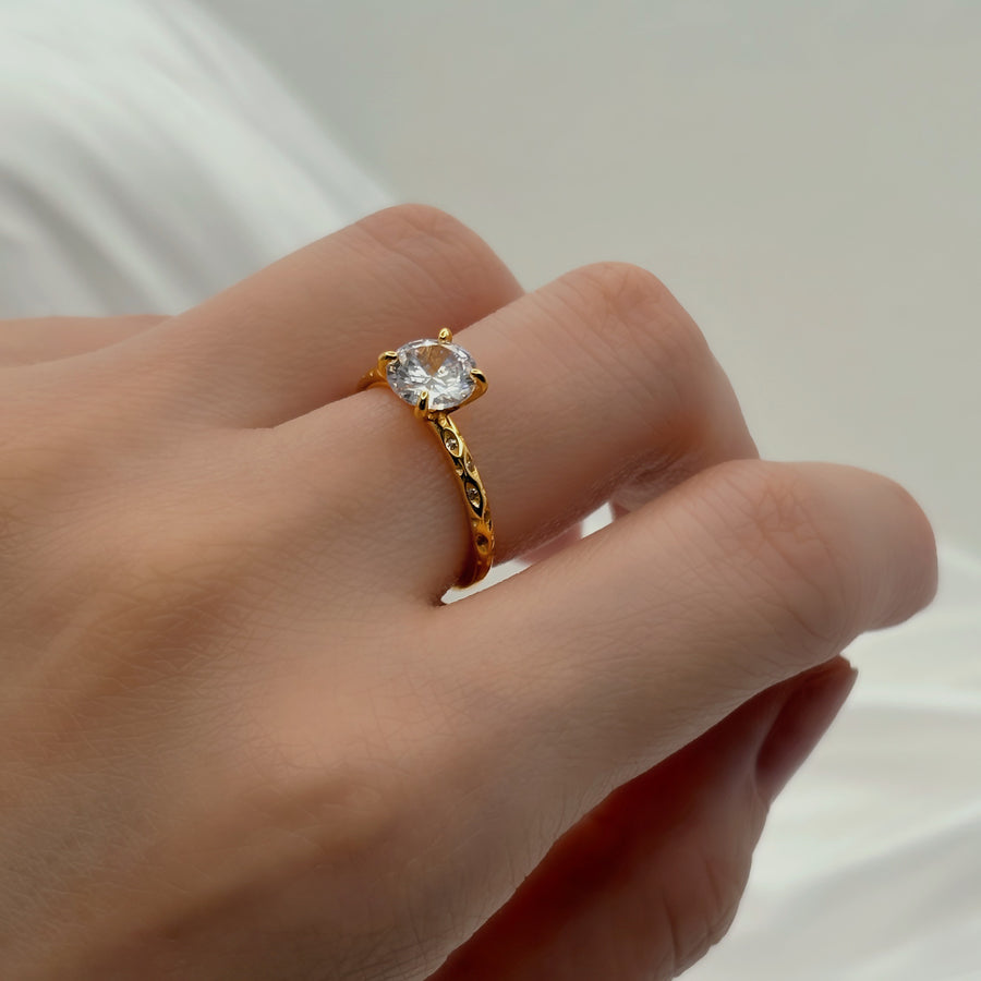 Gold vermeil Classic Ring. Featuring a brilliant round-cut cubic zircon set on a delicately textured gold band, this ring radiates timeless sophistication. 