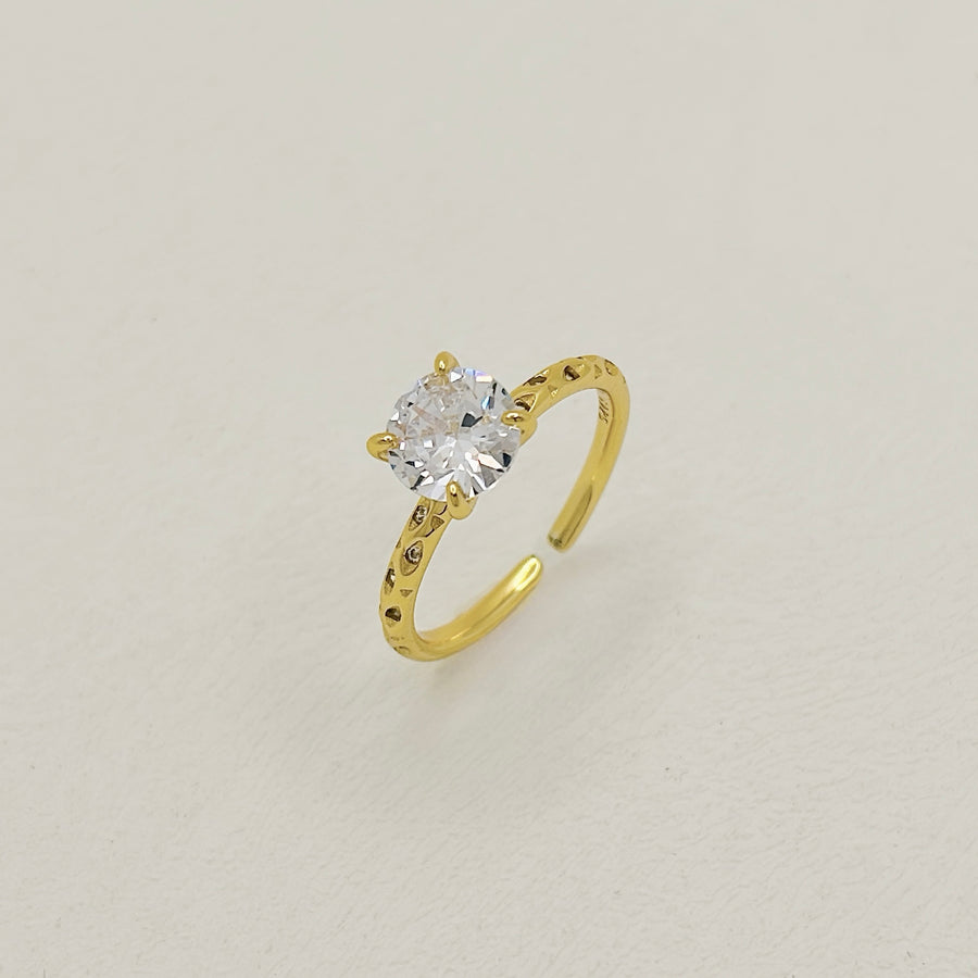 Gold vermeil Classic Ring. Featuring a brilliant round-cut cubic zircon set on a delicately textured gold band, this ring radiates timeless sophistication. 