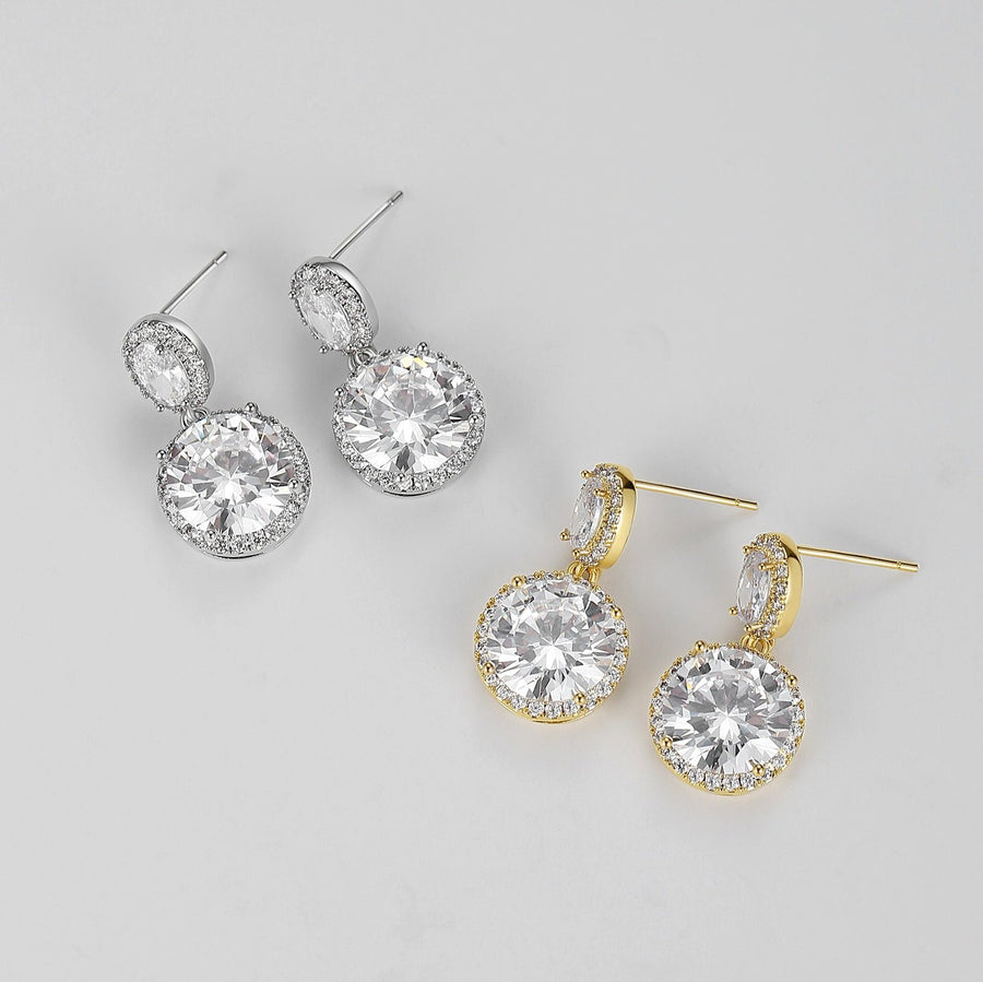 Crafted with precision-cut faceted crystals that catch and reflect light from every angle, these earrings are designed to add a touch of glamour to any outfit. The smaller stud crystal sits gracefully on the earlobe while the larger crystal dangles below, creating an eye-catching display of brilliance and shine. 