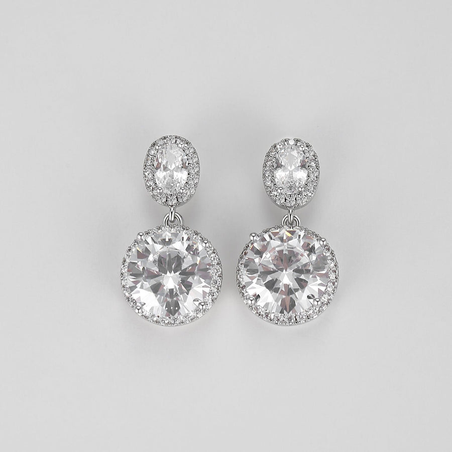 Crafted with precision-cut faceted crystals that catch and reflect light from every angle, these earrings are designed to add a touch of glamour to any outfit. The smaller stud crystal sits gracefully on the earlobe while the larger crystal dangles below, creating an eye-catching display of brilliance and shine. 