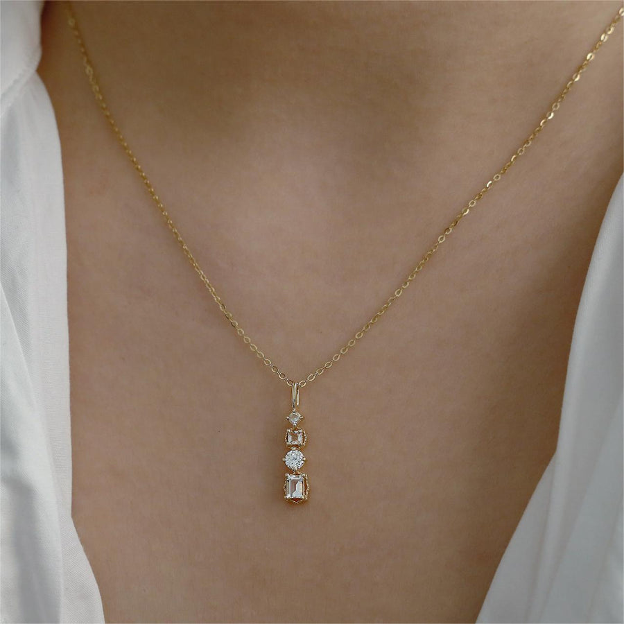 Add a touch of glamour to your look with this silver cubic zircon pendant necklace, featuring four dazzling stones on a delicate gold/ silver-tone chain. Perfect for any occasion, this elegant piece effortlessly combines sparkle and sophistication for a timeless accessory.