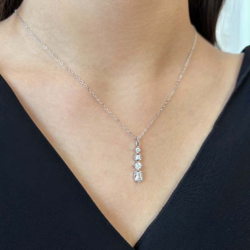 Add a touch of glamour to your look with this silver cubic zircon pendant necklace, featuring four dazzling stones on a delicate gold/ silver-tone chain. Perfect for any occasion, this elegant piece effortlessly combines sparkle and sophistication for a timeless accessory.