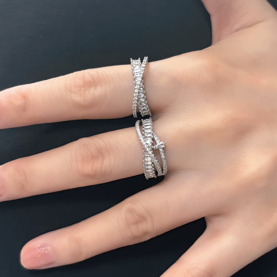 This dazzling sterling silver ring showcases an intricate layered design, adorned with rows of sparkling cubic zirconia for a luxurious touch. 