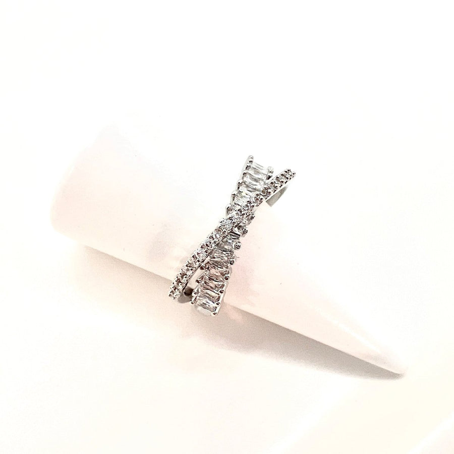 This dazzling sterling silver ring showcases an intricate layered design, adorned with rows of sparkling cubic zirconia for a luxurious touch. 