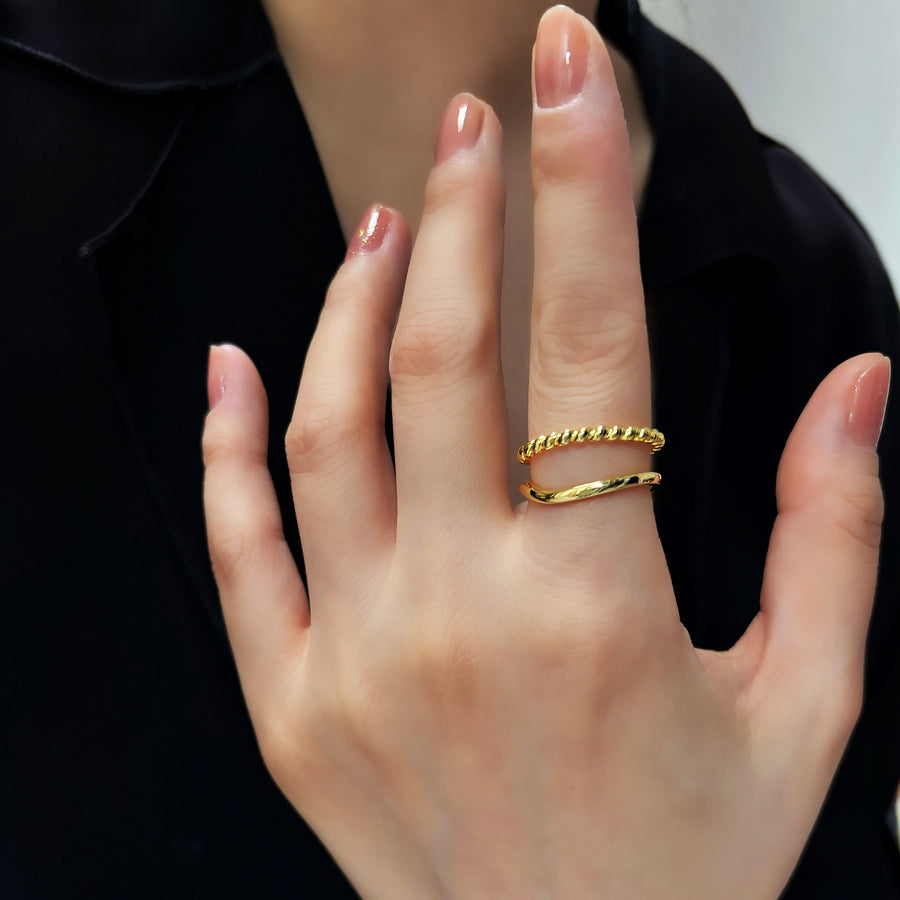 This gold ring features a sleek twisted band paired with a polished open ring, blending classic charm with modern sophistication. gold vermeil adjustable silver ring