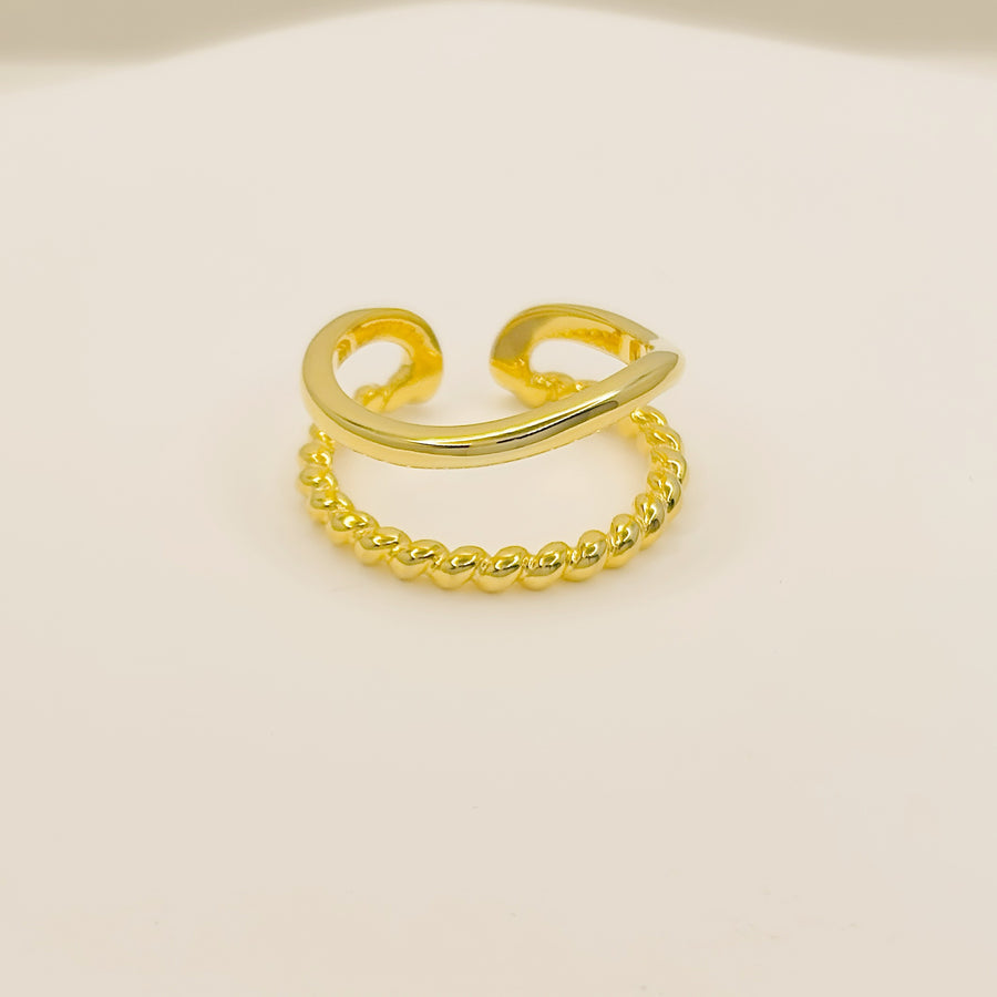 This gold ring features a sleek twisted band paired with a polished open ring, blending classic charm with modern sophistication. gold vermeil adjustable silver ring