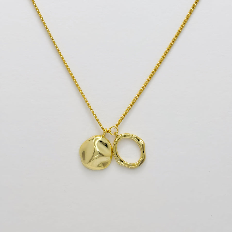 This gold-plated silver necklace features abstract pendants with a polished finish, creating a bold yet sophisticated look. Perfect for adding a touch of artistic flair to your outfits, this necklace is versatile for both casual and formal occasions.