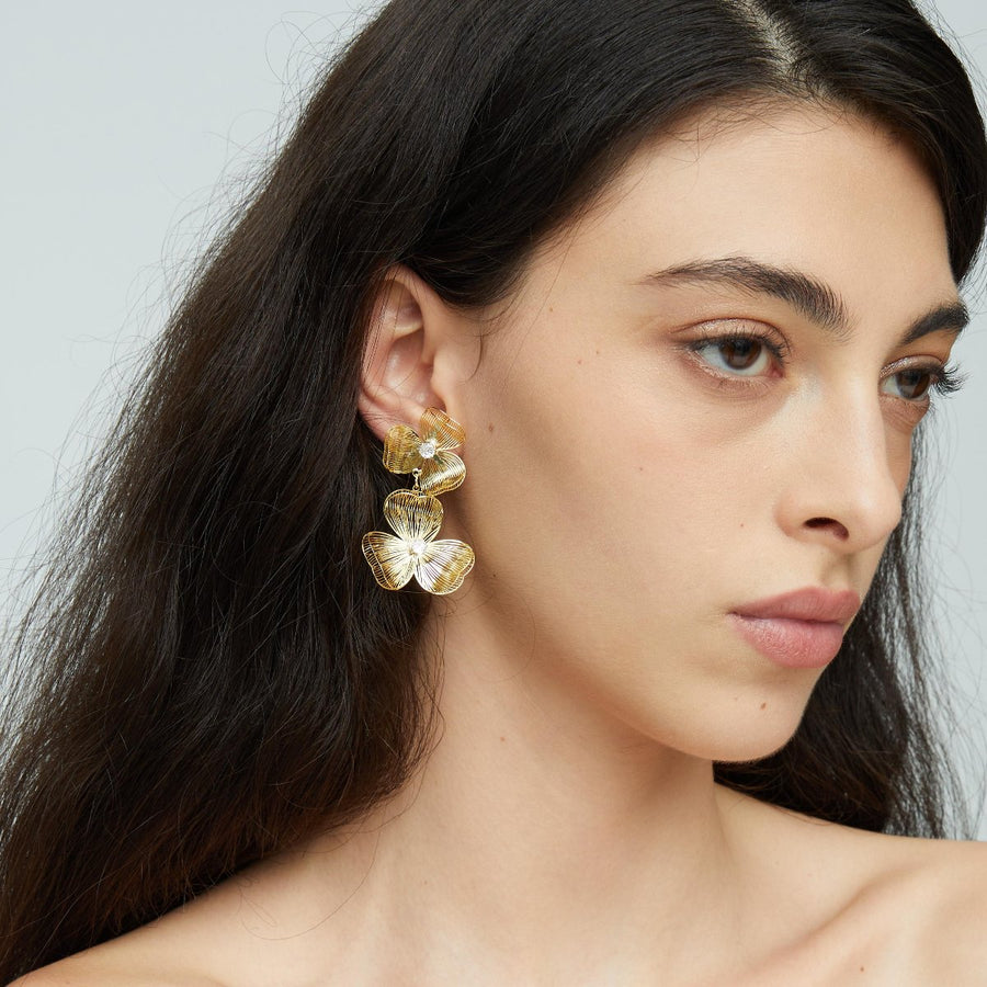 Each earring features two blossoms - one larger and one smaller - linked in harmonious beauty. The petals boast an incredibly lifelike texture that captures the delicate folds and curves found in nature’s own creations. 