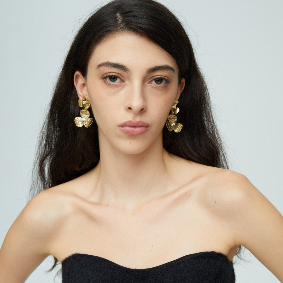 Each earring features two blossoms - one larger and one smaller - linked in harmonious beauty. The petals boast an incredibly lifelike texture that captures the delicate folds and curves found in nature’s own creations. 