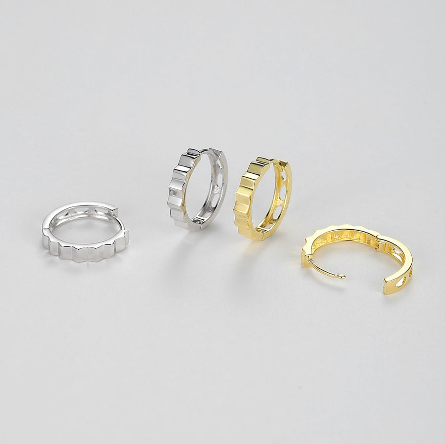 Elevate your accessory game with these sleek silver hoop earrings, designed for the modern fashion-forward individual. They are perfect for both day-to-night wear and special occasions where you want to make a subtle yet impactful statement. 