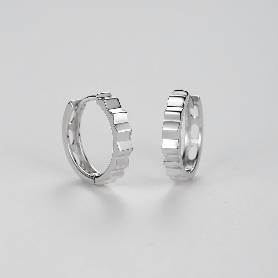 Elevate your accessory game with these sleek silver hoop earrings, designed for the modern fashion-forward individual. They are perfect for both day-to-night wear and special occasions where you want to make a subtle yet impactful statement. 