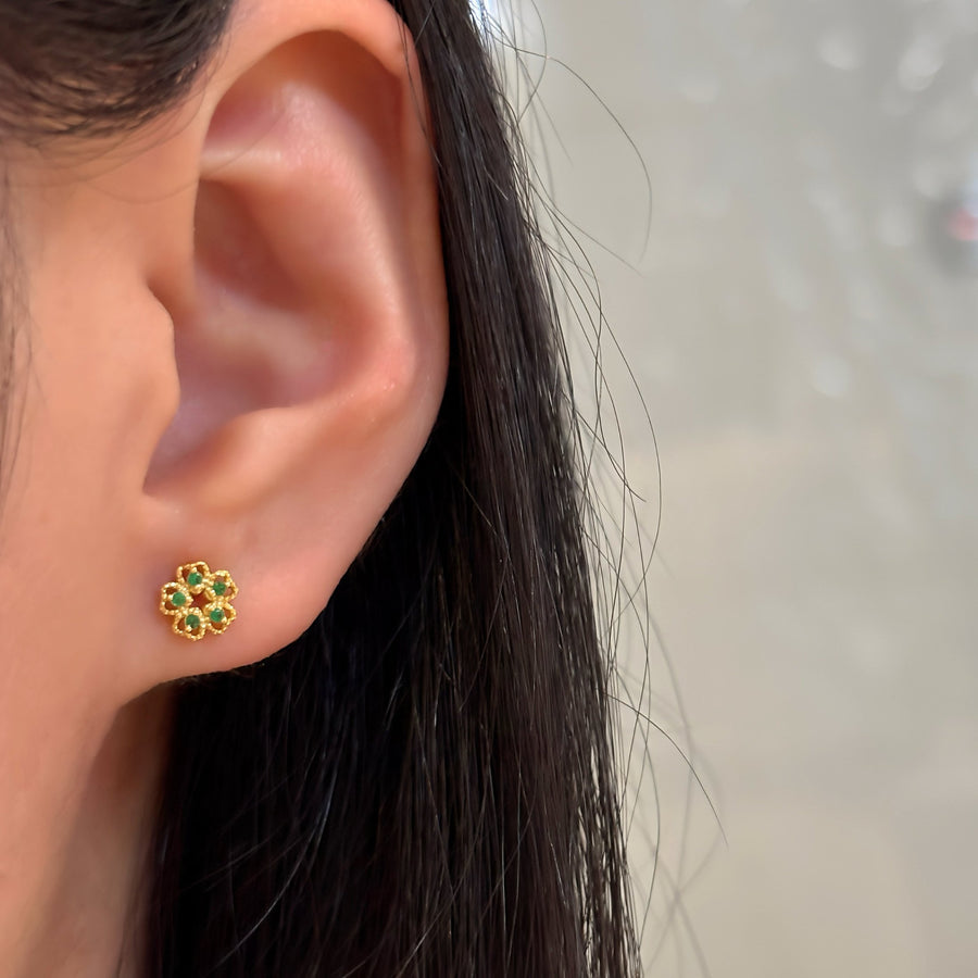 These exquisite earrings feature a delicate floral design, crafted from high-quality gold and adorned with vibrant green cubic zircon. Perfect for adding a touch of elegance and sophistication to any outfit, these earrings are a must-have accessory for any jewelry collection. 