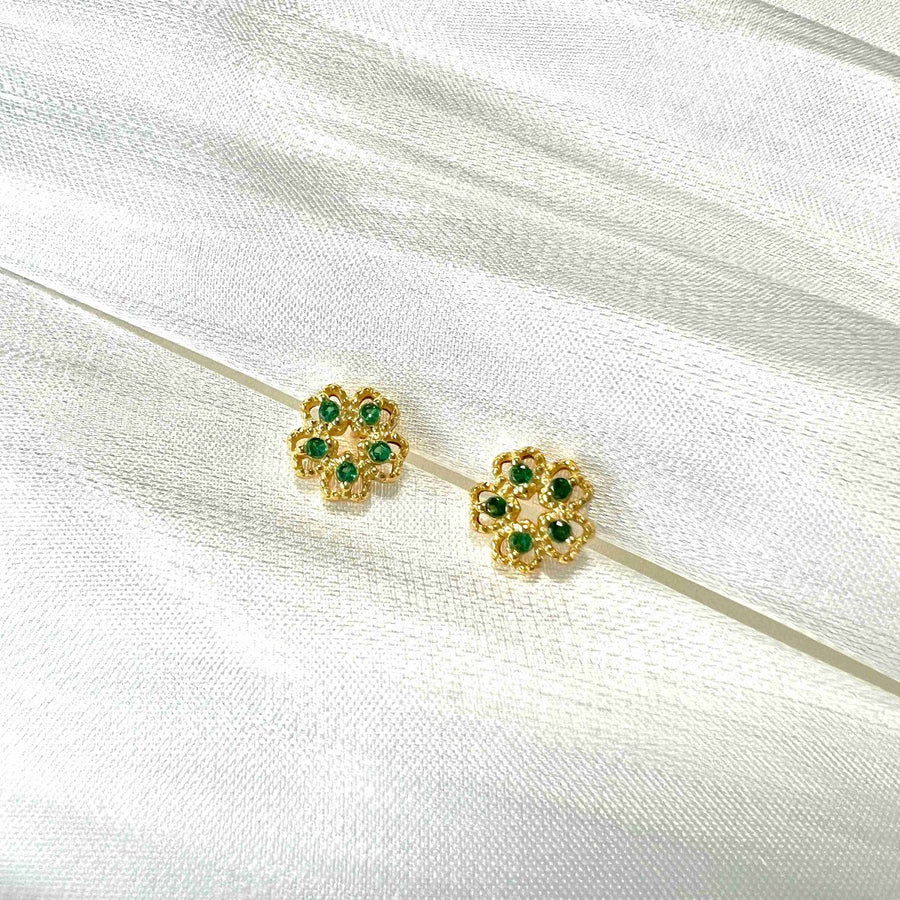 These exquisite earrings feature a delicate floral design, crafted from high-quality gold and adorned with vibrant green cubic zircon. Perfect for adding a touch of elegance and sophistication to any outfit, these earrings are a must-have accessory for any jewelry collection. 