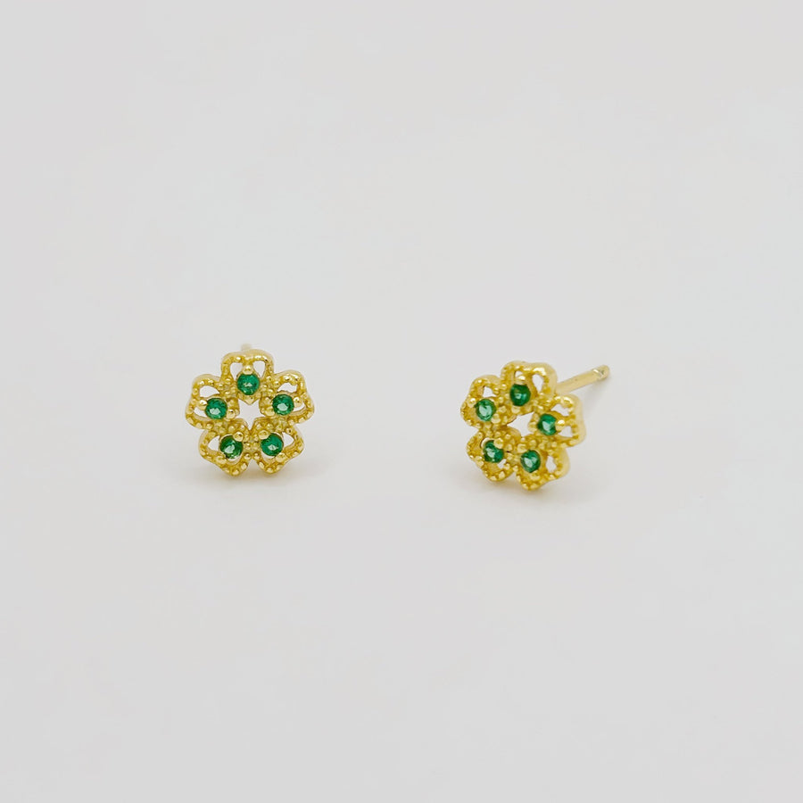 These exquisite earrings feature a delicate floral design, crafted from high-quality gold and adorned with vibrant green cubic zircon. Perfect for adding a touch of elegance and sophistication to any outfit, these earrings are a must-have accessory for any jewelry collection. 