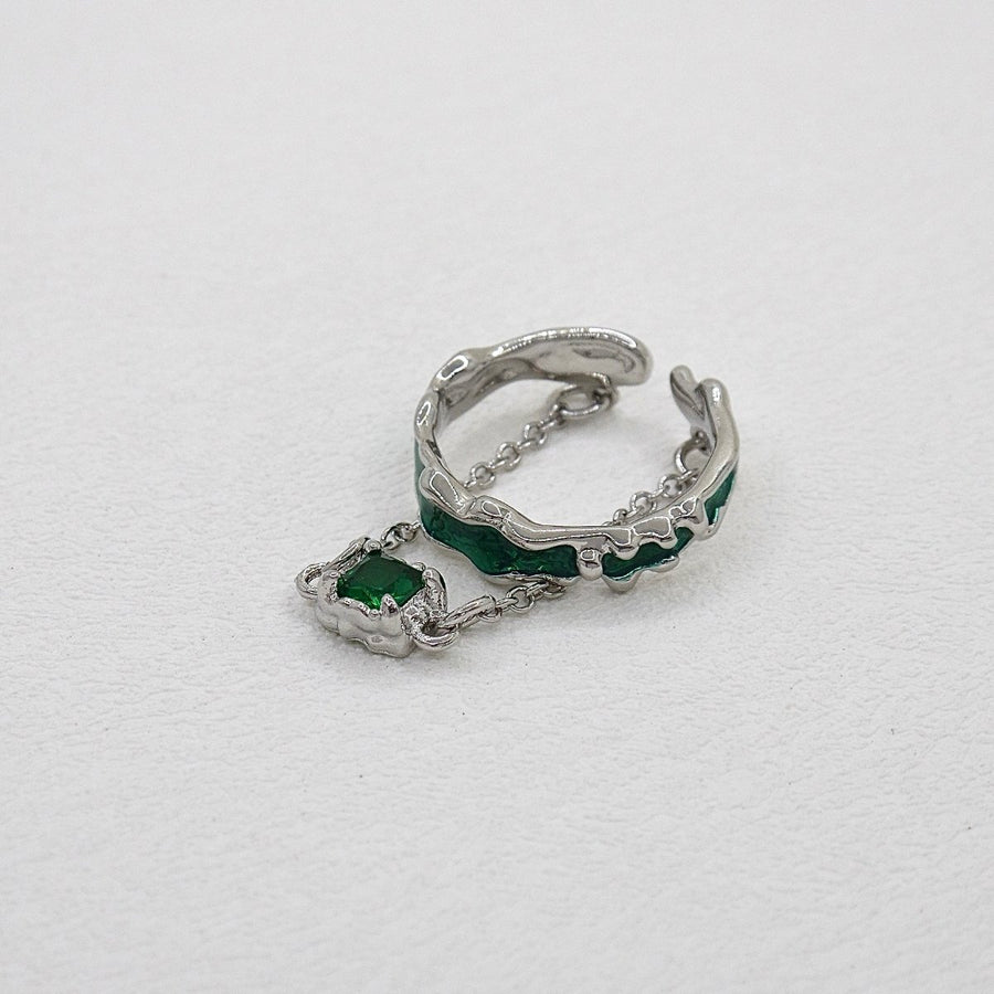 This sterling silver ring features a unique and intricate design, showcasing a beautiful emerald green zircon as its centerpiece. Perfect for those who appreciate a touch of individuality in their accessories. 