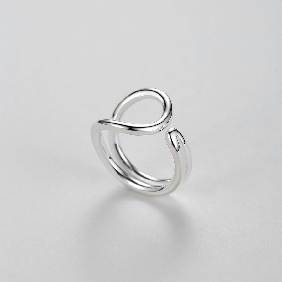 This silver ring features an elegant, flowing design inspired by the infinity symbol, representing timelessness and boundless possibilities.