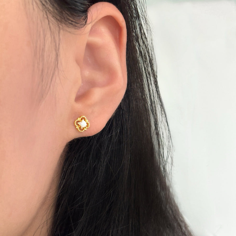 Delicately crafted, these gold-plated stud earrings feature an intricate floral design with a luminous opal center. Elegant and timeless, they add a subtle yet enchanting touch to your everyday style or special occasions. 