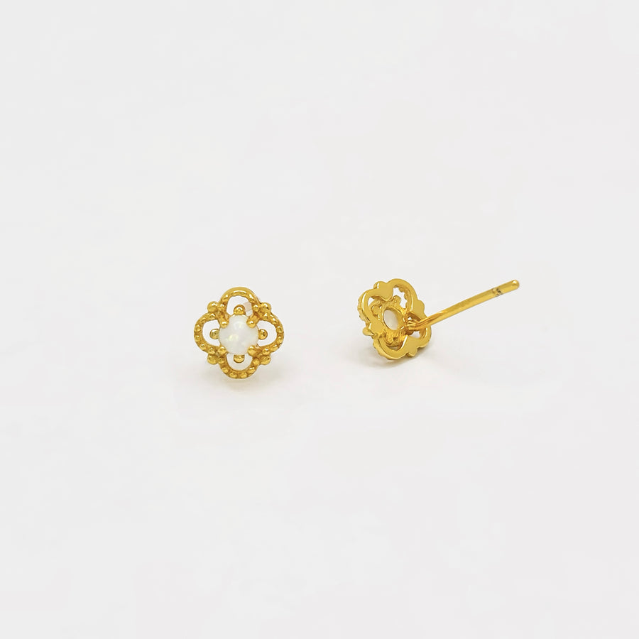 Delicately crafted, these gold-plated stud earrings feature an intricate floral design with a luminous opal center. Elegant and timeless, they add a subtle yet enchanting touch to your everyday style or special occasions. 