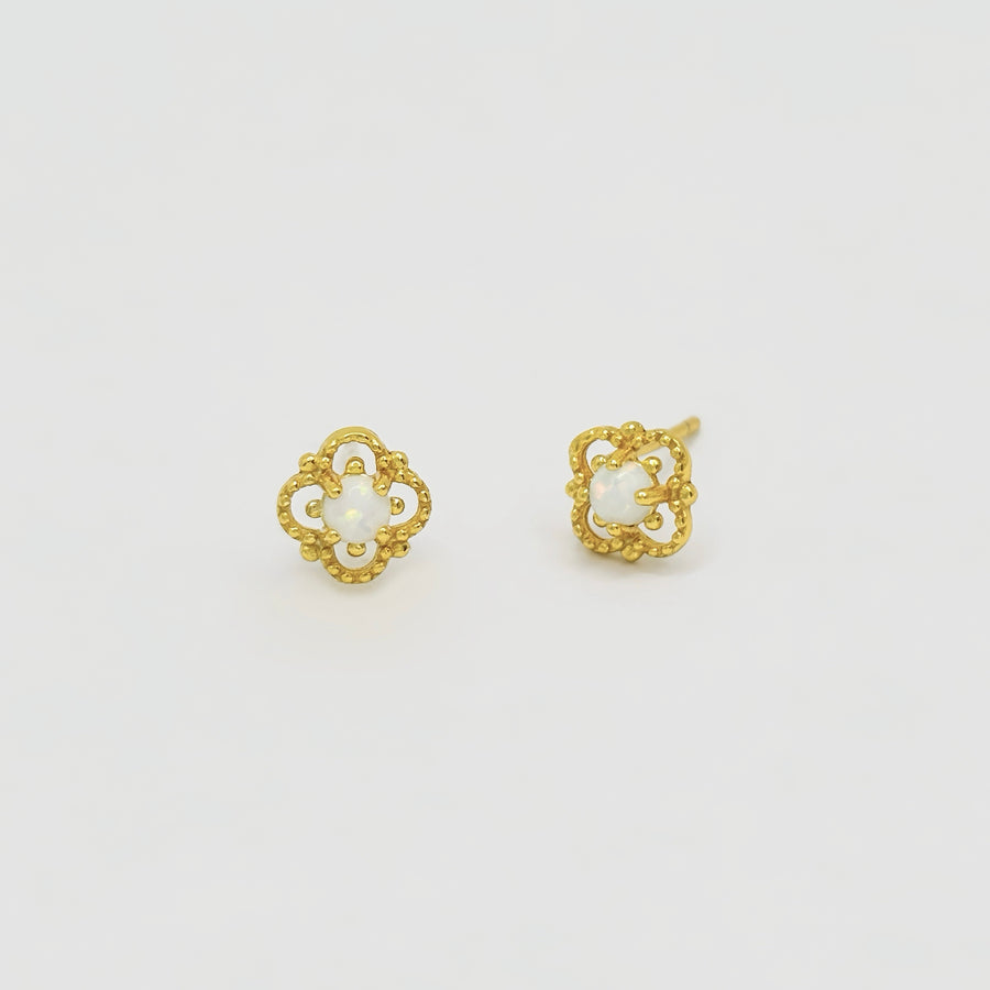 Delicately crafted, these gold-plated stud earrings feature an intricate floral design with a luminous opal center. Elegant and timeless, they add a subtle yet enchanting touch to your everyday style or special occasions. 