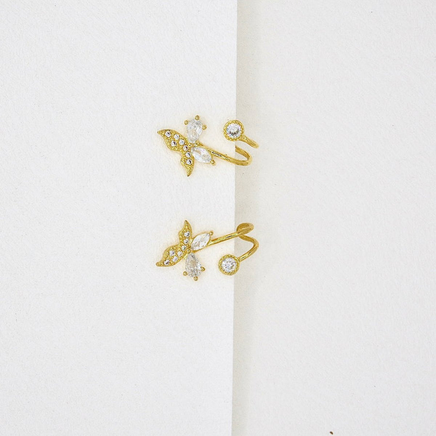 Crafted with sparkling cubic zircon and delicate gold details, these whimsical butterflies are perfect for adding elegance and charm to any look. A must-have for those who love a touch of nature's beauty.