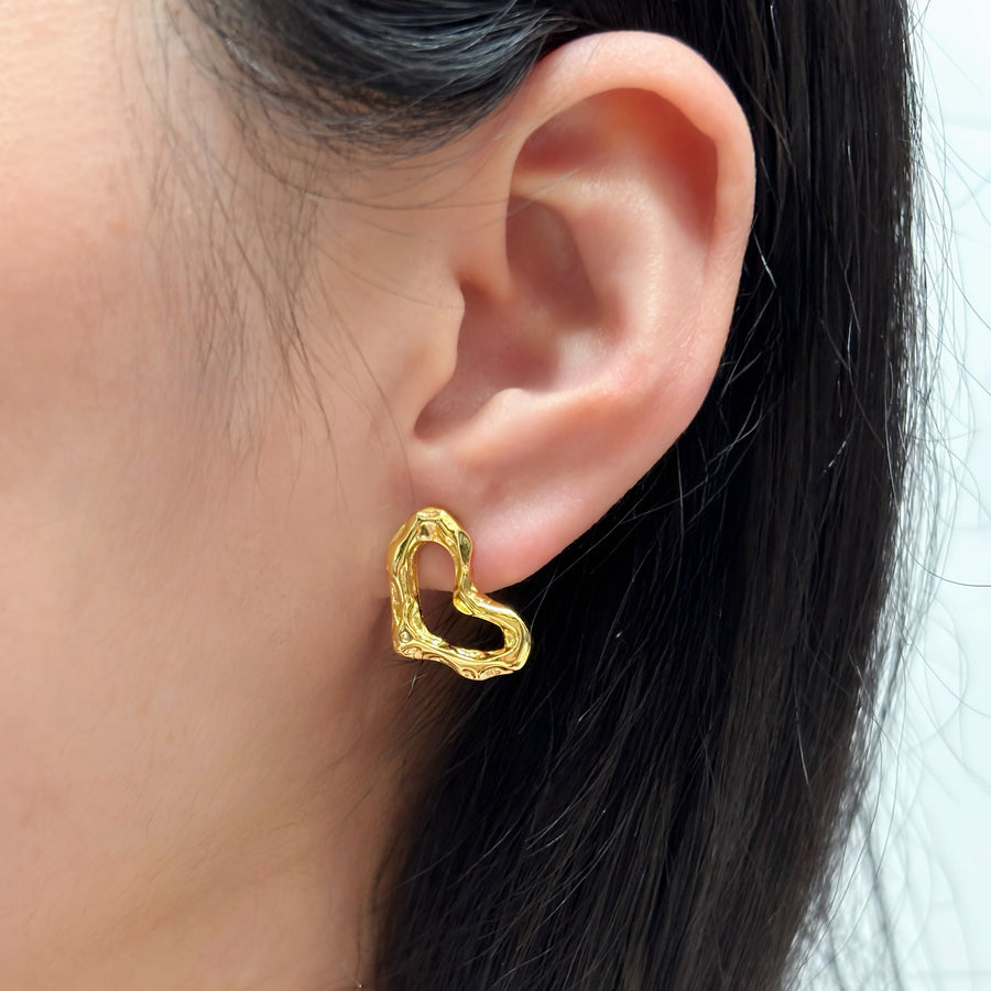 These exquisite earrings feature a unique, heart-shaped design crafted from gold vermeil, adding a touch of modern elegance to any outfit. 925 silver earrings.