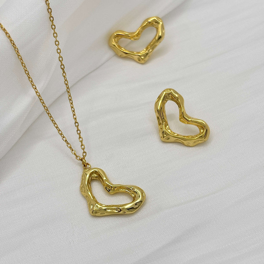 These exquisite earrings feature a unique, heart-shaped design crafted from gold vermeil, adding a touch of modern elegance to any outfit. 925 silver earrings.