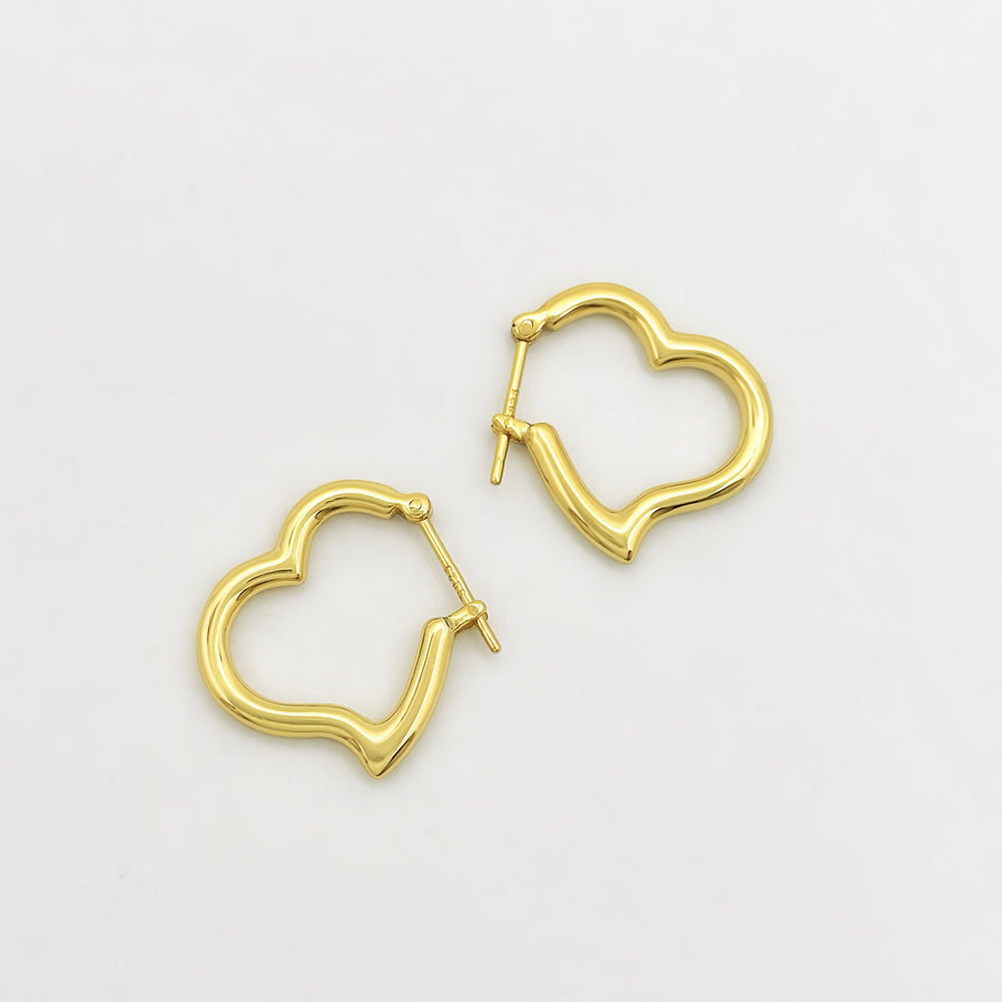 These elegant gold vermeil heart-shaped hoop earrings are a timeless addition to any jewelry collection. With their sleek design and polished finish, they effortlessly combine sophistication and charm for any occasion.