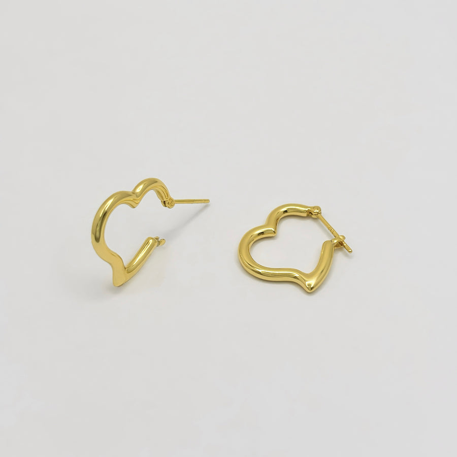 These elegant gold vermeil heart-shaped hoop earrings are a timeless addition to any jewelry collection. With their sleek design and polished finish, they effortlessly combine sophistication and charm for any occasion.