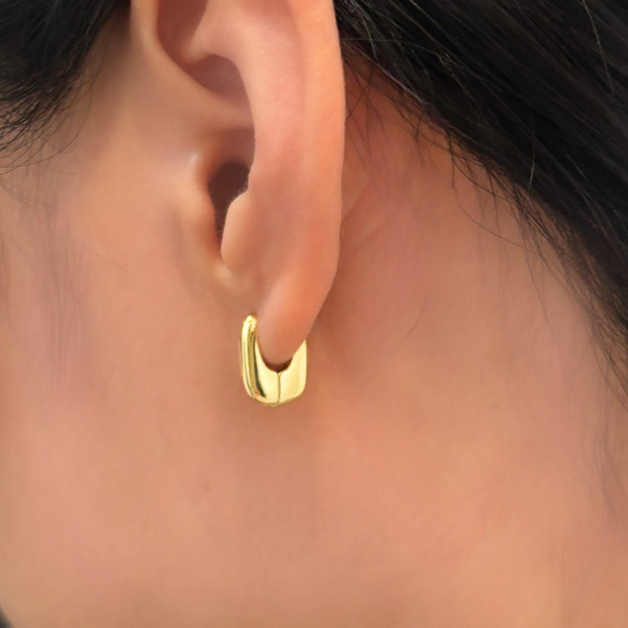 These elegant gold hoop earrings feature a sleek, modern design that effortlessly complements any outfit. The polished finish and minimalistic style make these hoops a versatile addition to both casual and formal looks.