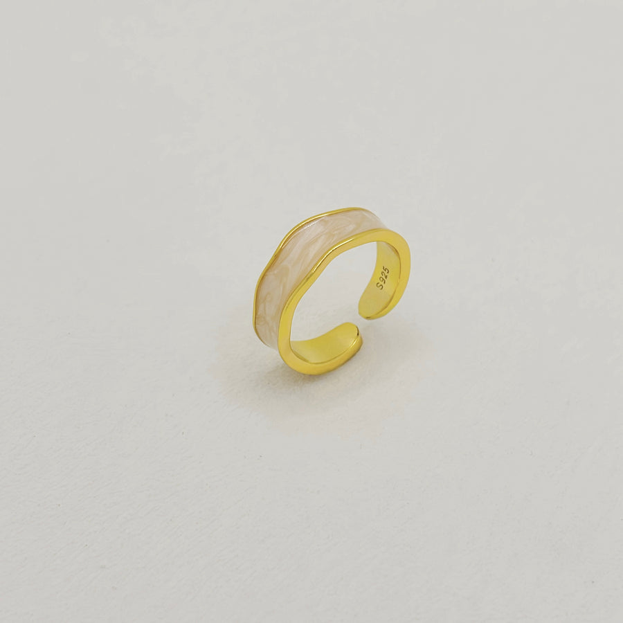 925 silver ring.  The combination of smooth gold and pastel pink resin creates a timeless and chic accessory for any occasion. Designed with a modern open-band style. 