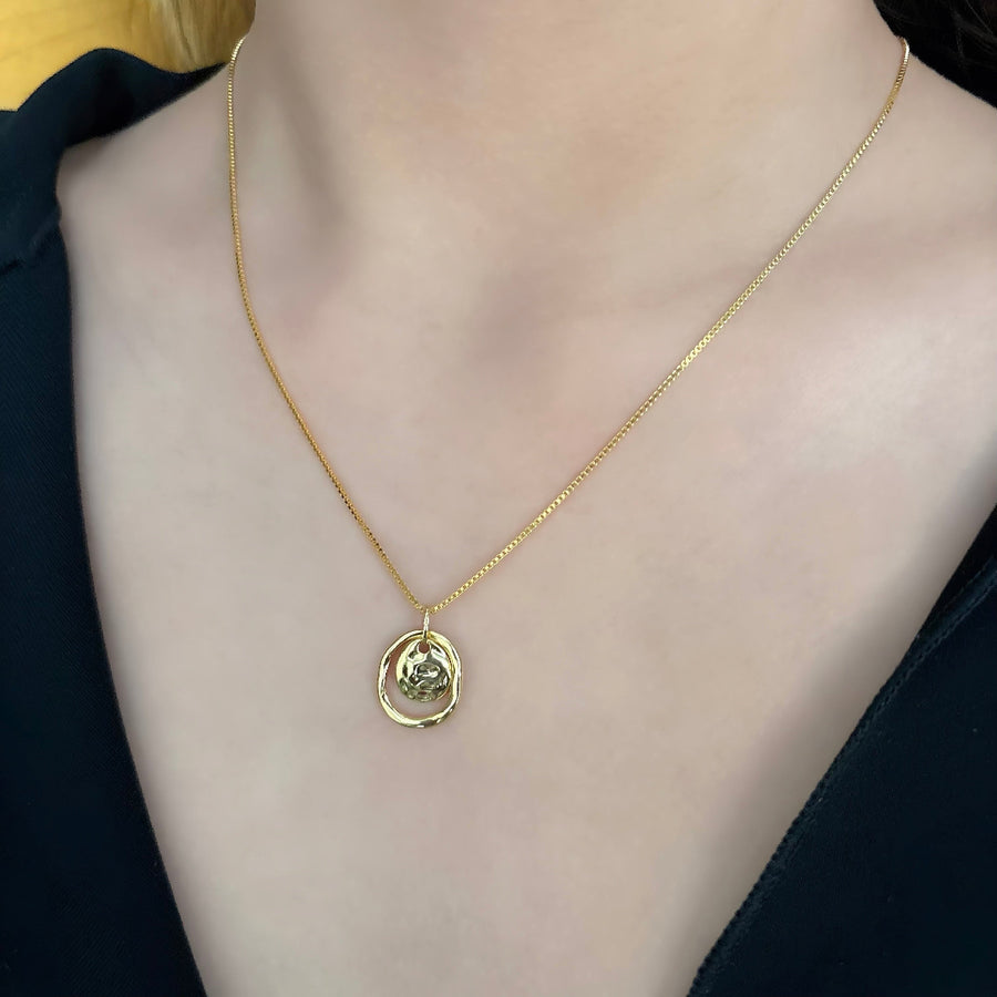 Make a bold statement with this artistic gold pendant necklace, featuring textured details for a modern, sculptural appeal. Perfectly versatile, this necklace adds a touch of elegance and individuality to your everyday style.