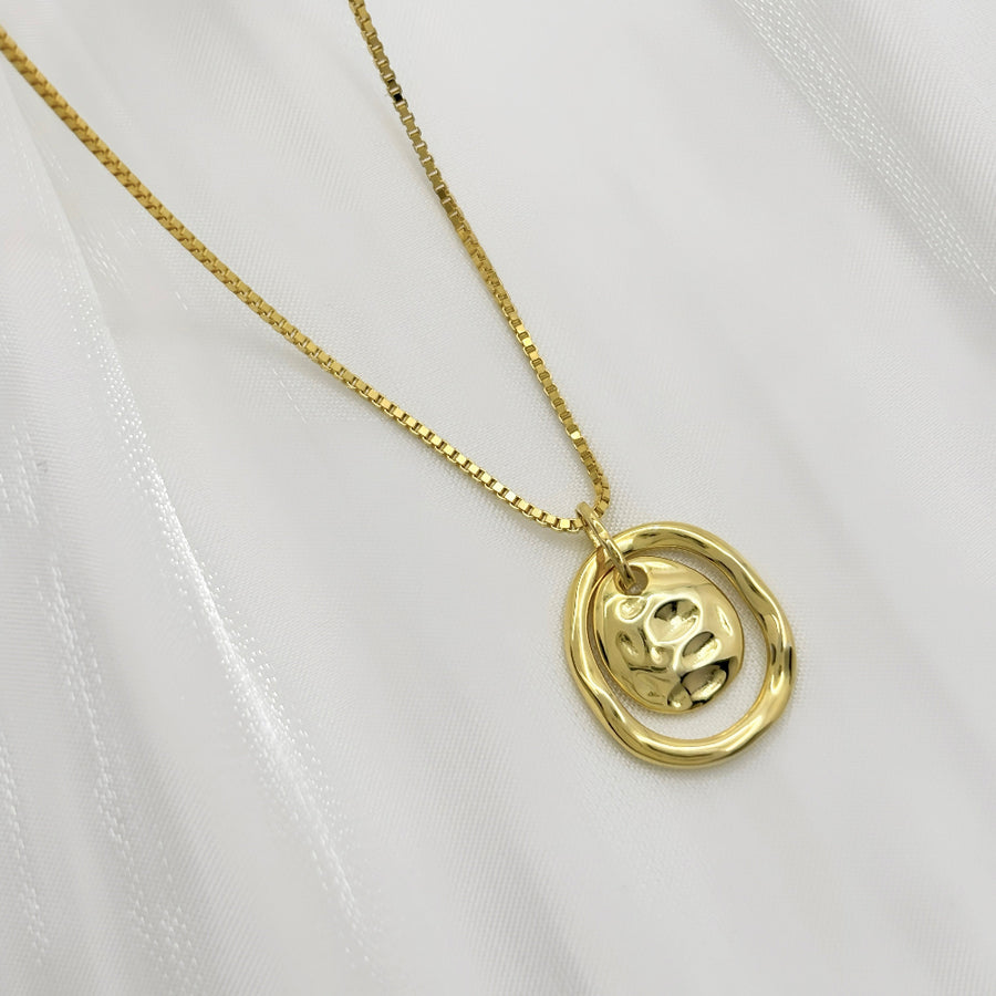 Make a bold statement with this artistic gold pendant necklace, featuring textured details for a modern, sculptural appeal. Perfectly versatile, this necklace adds a touch of elegance and individuality to your everyday style.