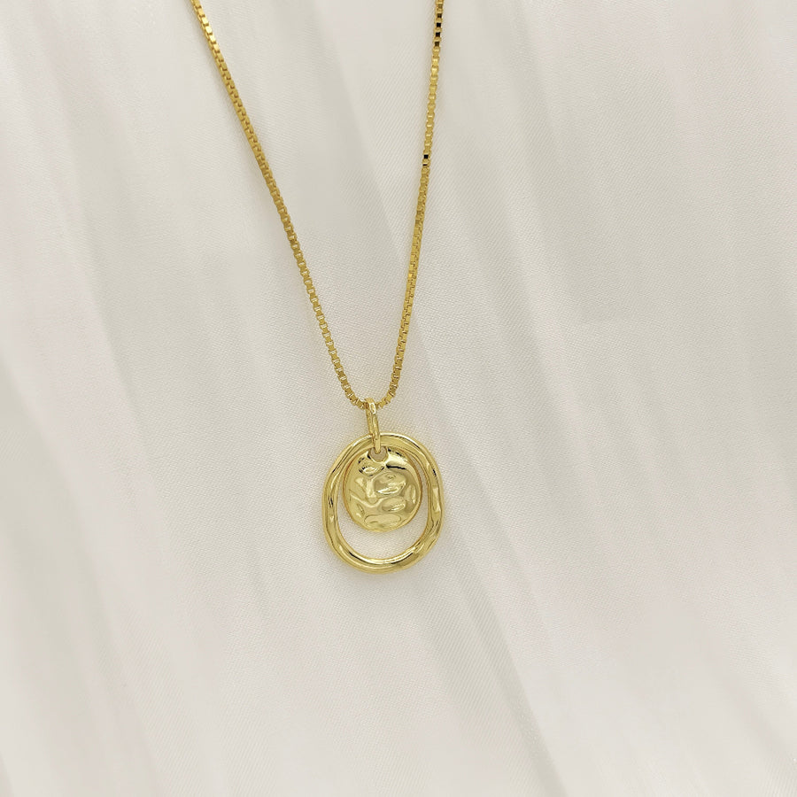Make a bold statement with this artistic gold pendant necklace, featuring textured details for a modern, sculptural appeal. Perfectly versatile, this necklace adds a touch of elegance and individuality to your everyday style.