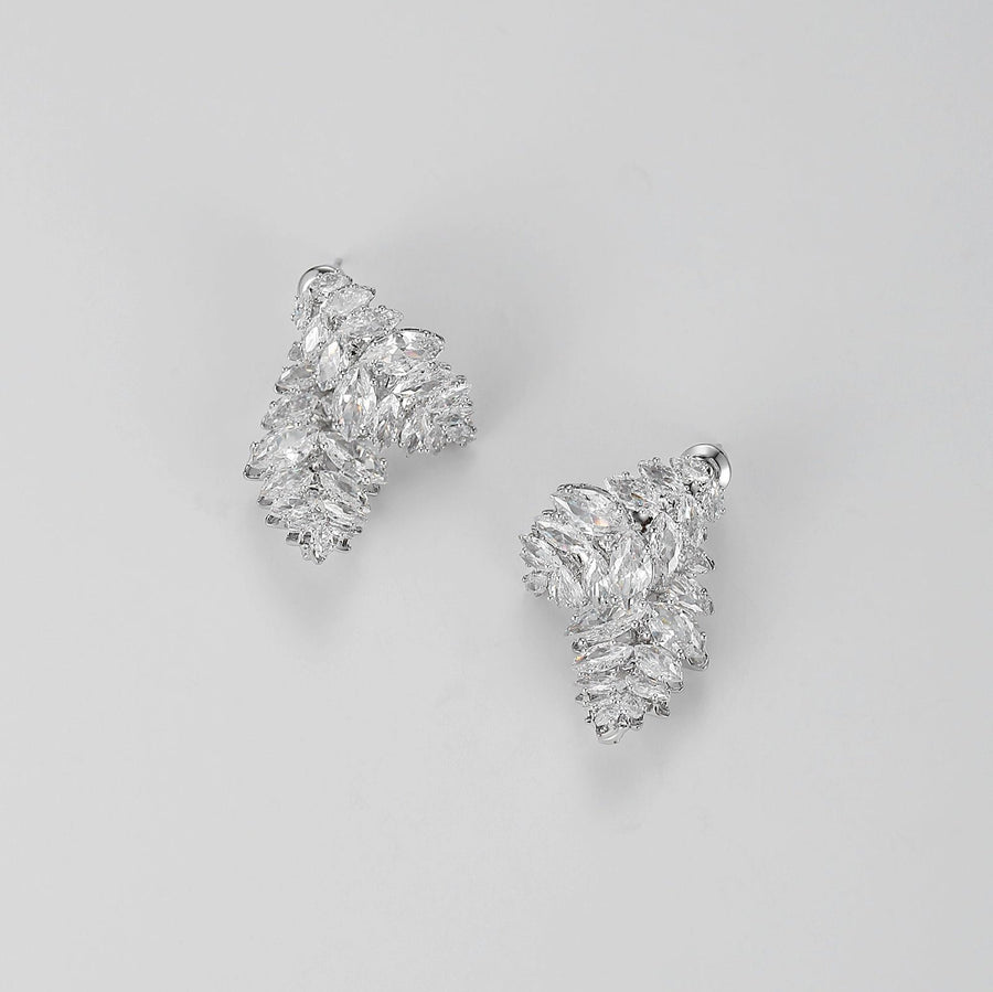 Each earring features a unique design of two overlapping leaf shapes, intricately adorned with sparkling olive-shaped cubic zirconia. Perfect for special occasions or to elevate your everyday style, these earrings are a must-have for anyone who loves detailed and opulent accessories.