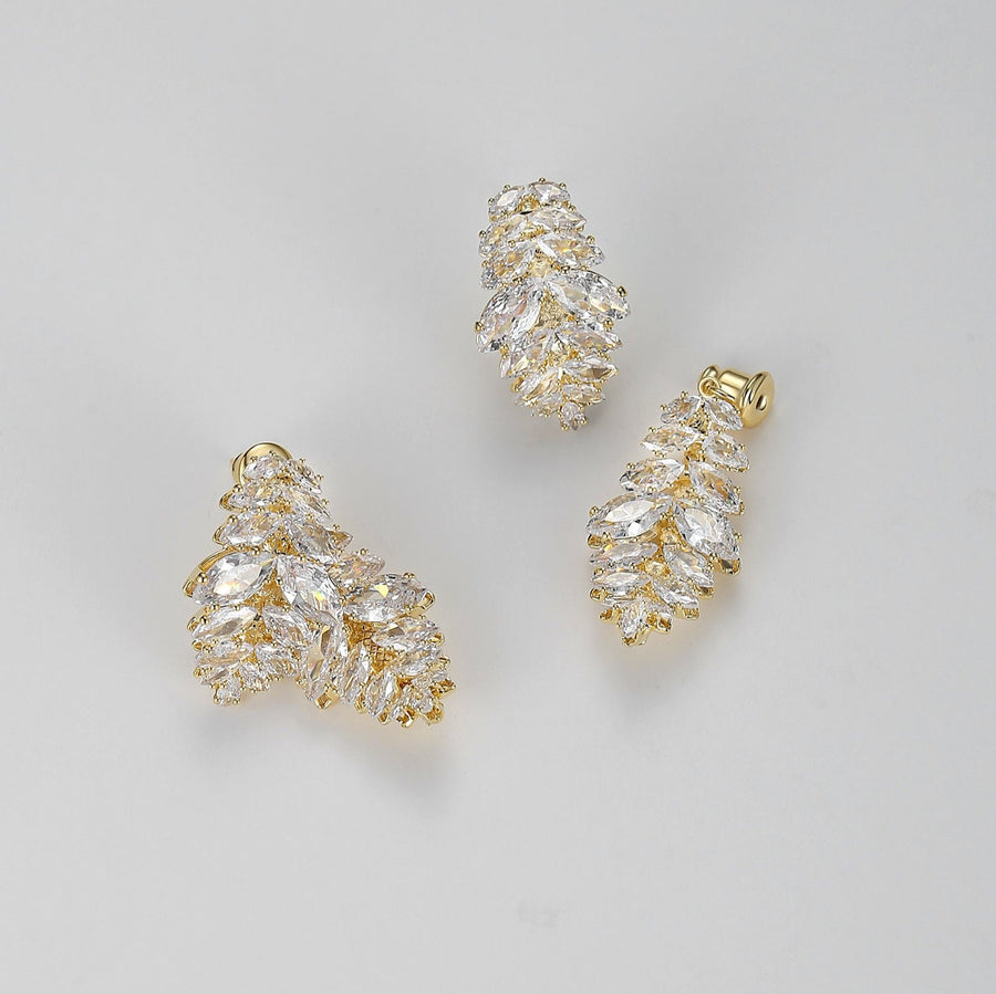 Each earring features a unique design of two overlapping leaf shapes, intricately adorned with sparkling olive-shaped cubic zirconia. Perfect for special occasions or to elevate your everyday style, these earrings are a must-have for anyone who loves detailed and opulent accessories.