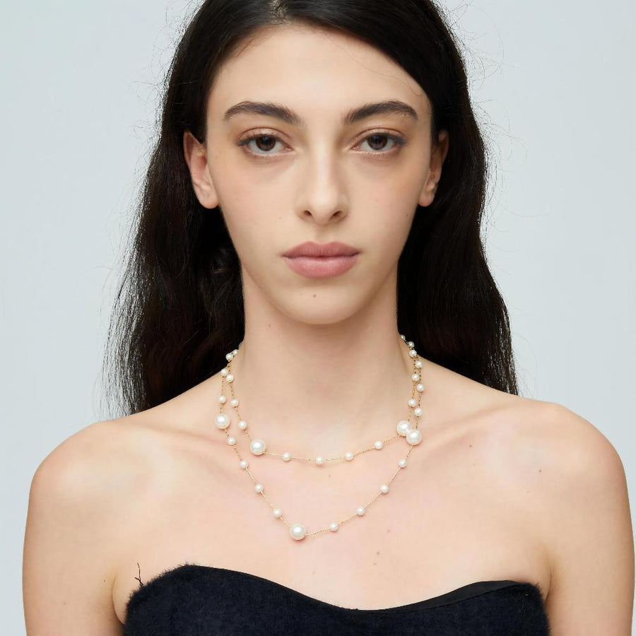 Crafted with lustrous, creamy white pearls delicately placed along fine gold-toned chains, this piece exudes sophistication and grace. Perfect for both formal occasions and everyday wear, this versatile necklace promises to be a timeless addition to any jewelry collection.