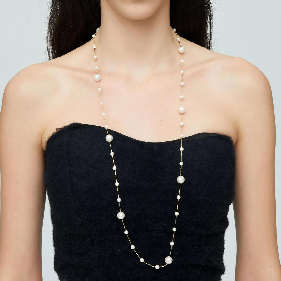 Crafted with lustrous, creamy white pearls delicately placed along fine gold-toned chains, this piece exudes sophistication and grace. Perfect for both formal occasions and everyday wear, this versatile necklace promises to be a timeless addition to any jewelry collection.