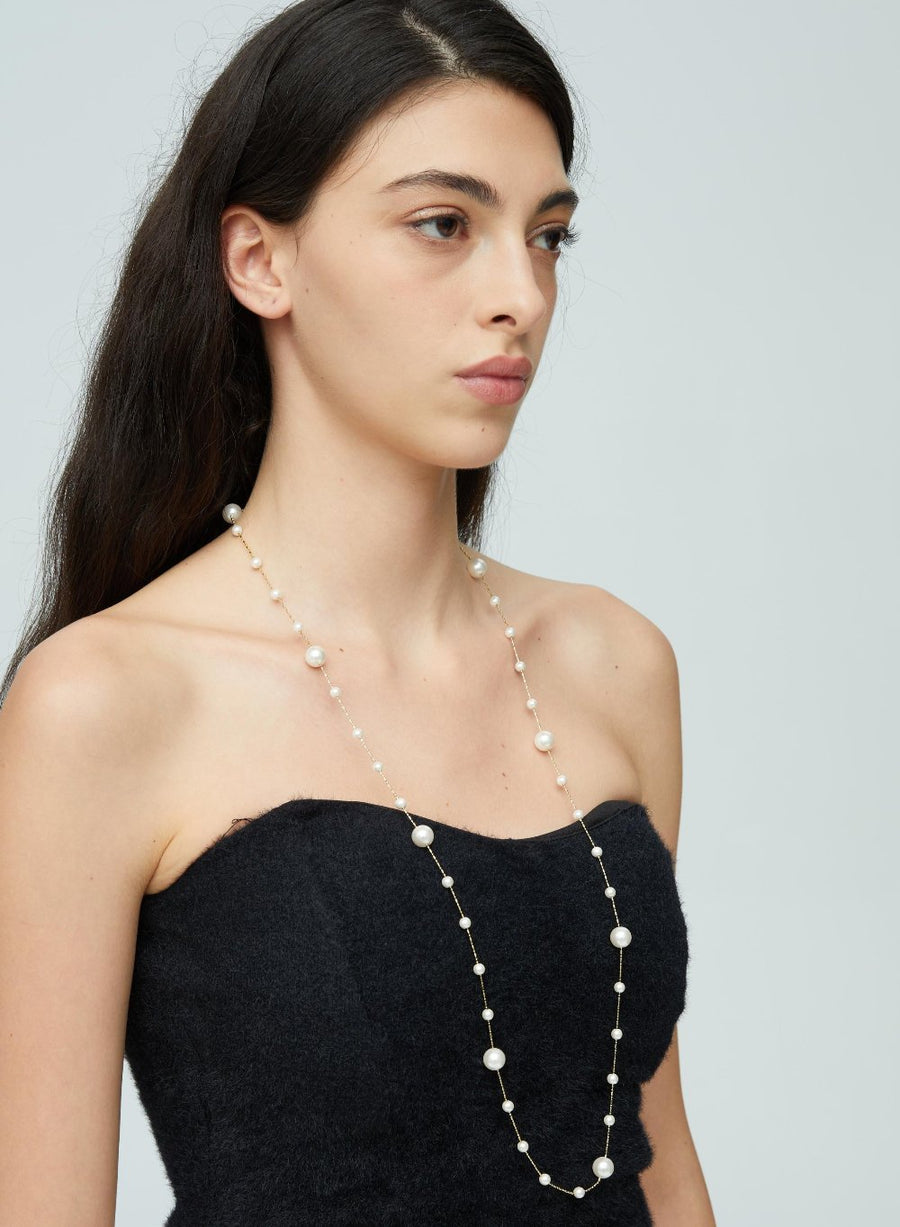 Crafted with lustrous, creamy white pearls delicately placed along fine gold-toned chains, this piece exudes sophistication and grace. Perfect for both formal occasions and everyday wear, this versatile necklace promises to be a timeless addition to any jewelry collection.