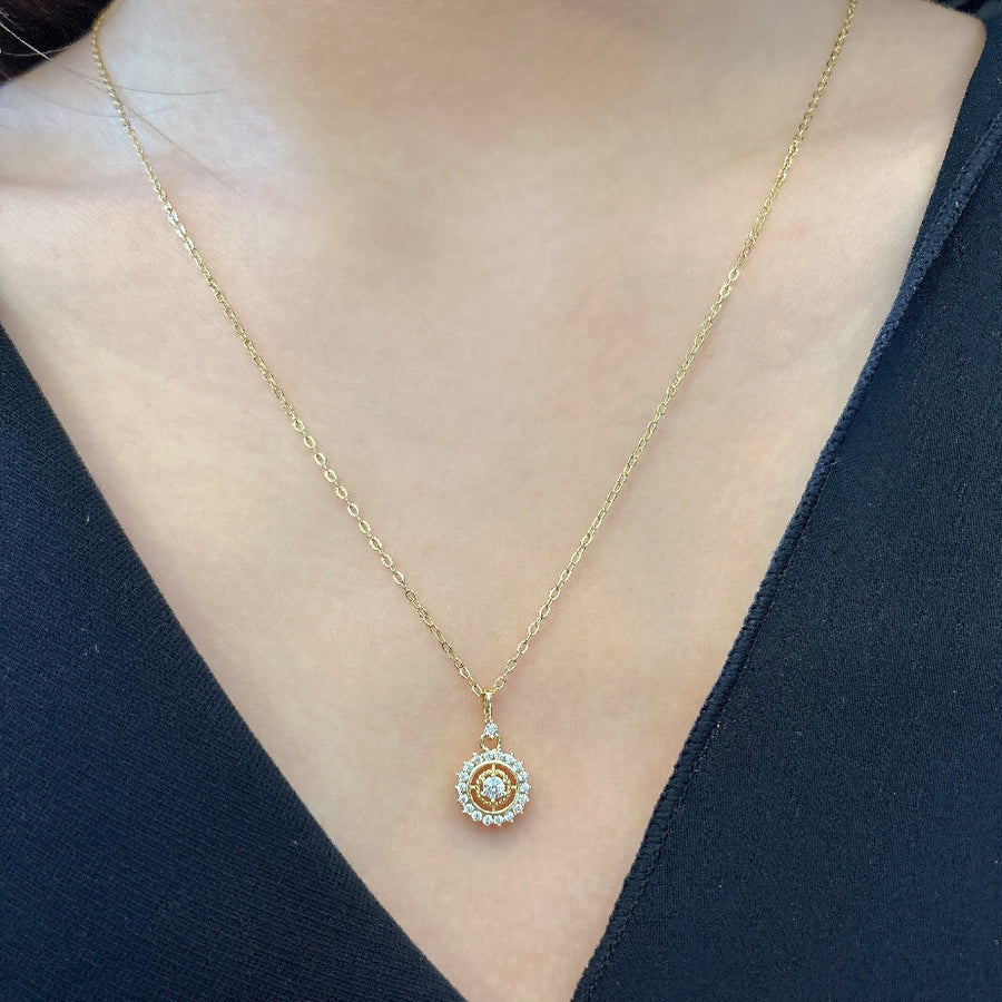 The silver pendant necklace showcases a central zircon stone surrounded by a halo of smaller zircons, creating a radiant and elegant design. Perfect for special occasions or everyday wear, this necklace adds a touch of timeless sophistication to any outfit with its brilliant sparkle.