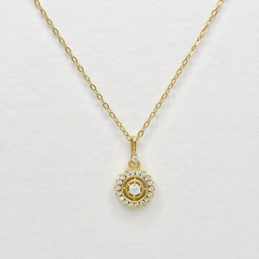 The silver pendant necklace showcases a central zircon stone surrounded by a halo of smaller zircons, creating a radiant and elegant design. Perfect for special occasions or everyday wear, this necklace adds a touch of timeless sophistication to any outfit with its brilliant sparkle.